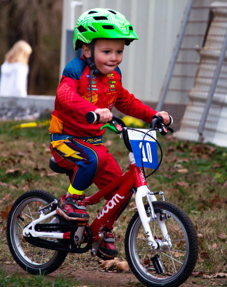 3 year old child learning how to ride a bicycle