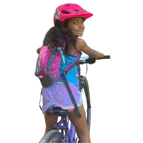 Girl on bike smiling and looking back over her shoulder