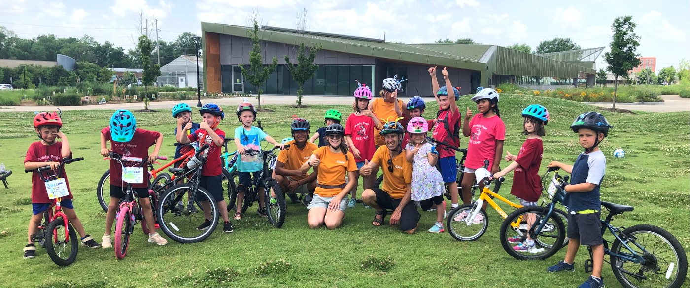 Elementary age kids and bike coaches at a Buddy Pegs bike club Bentonville Arkansas