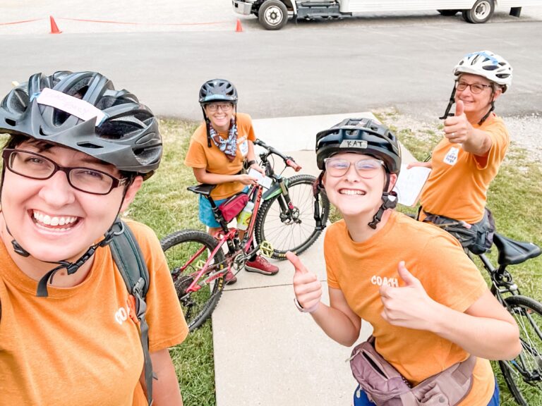 coach teaching kids how to ride mountain bikes